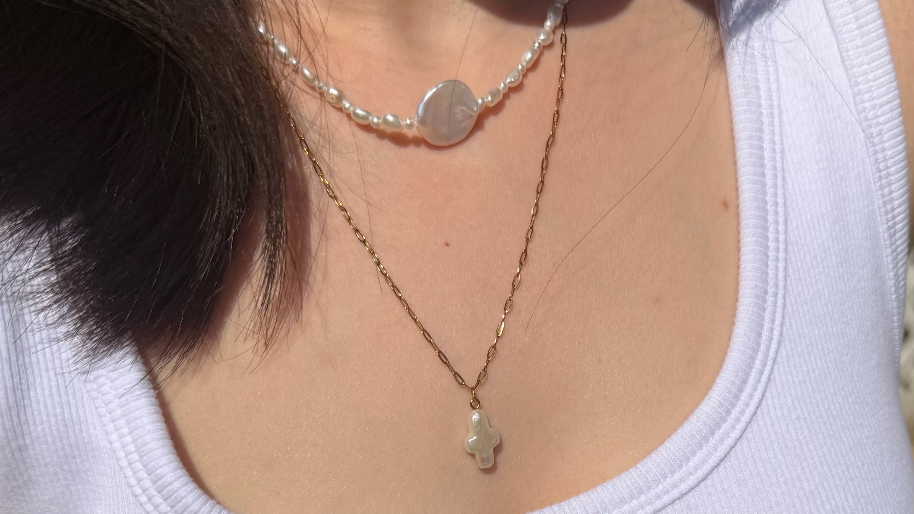 Freshwater pearl necklace layered with a simple gold chain for everyday style