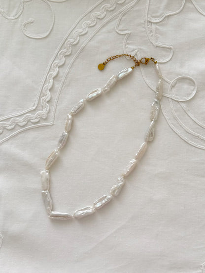 Biwa pearl necklace flat lay with organic freshwater pearl details