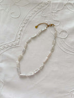 Biwa pearl necklace flat lay with organic freshwater pearl details