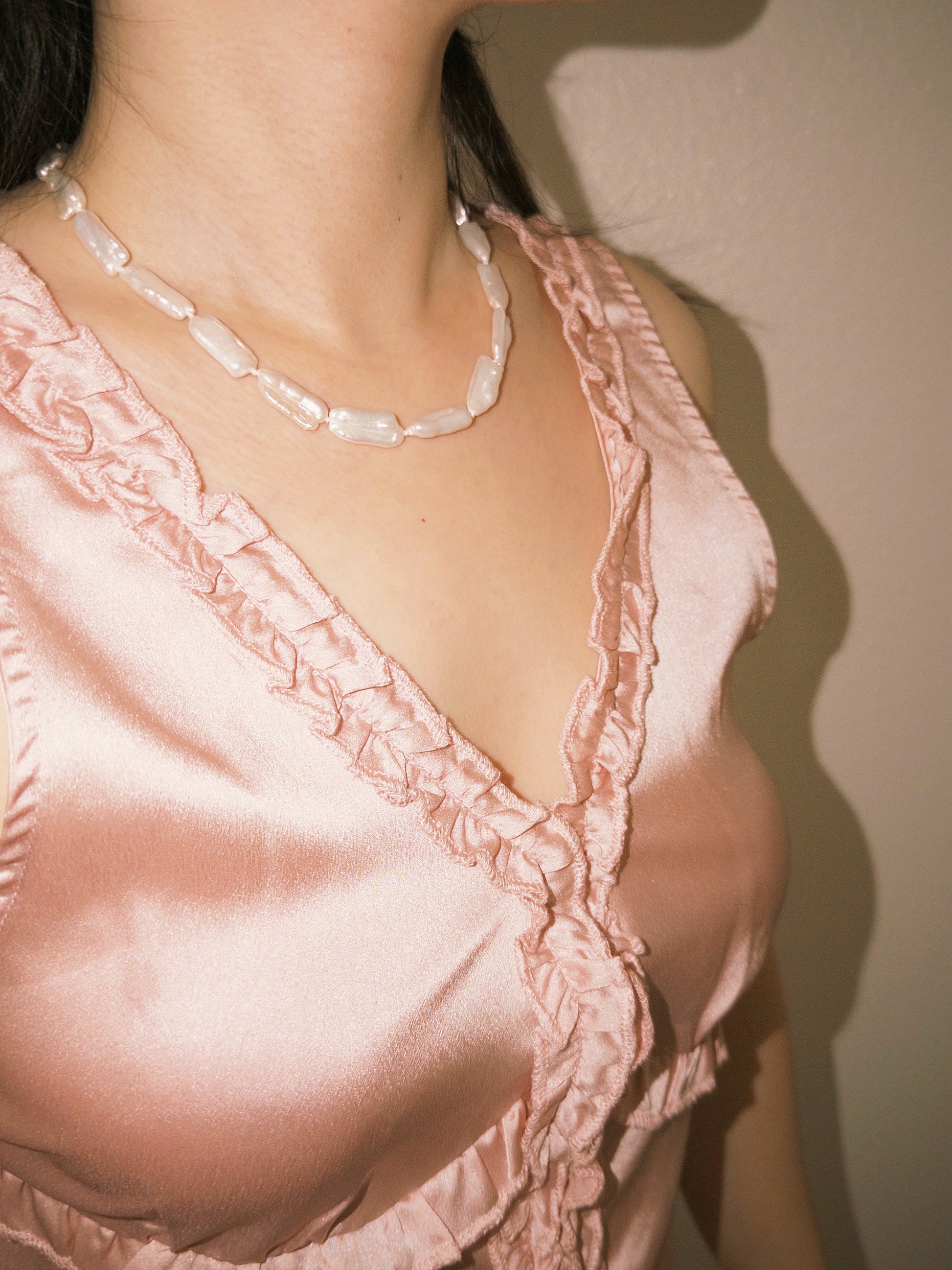 Biwa pearl necklace worn casually with soft feminine styling