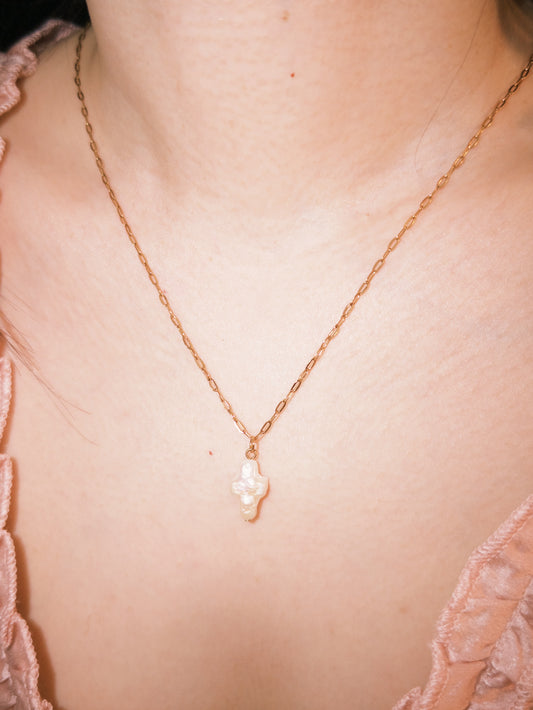 Delicate pearl cross necklace styled softly for everyday wear