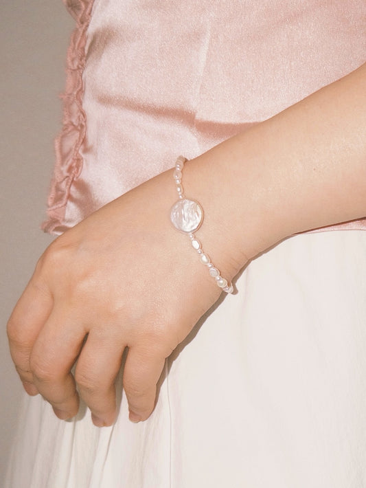 Freshwater pearl bracelet with a statement pearl centerpiece styled softly for everyday wear