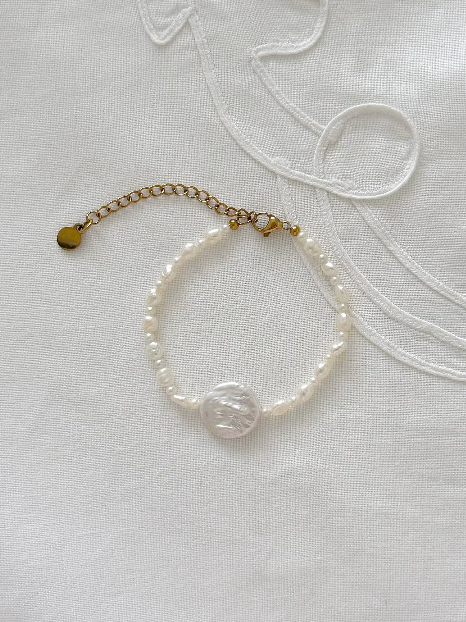 Freshwater pearl bracelet displayed on soft fabric with minimal styling details