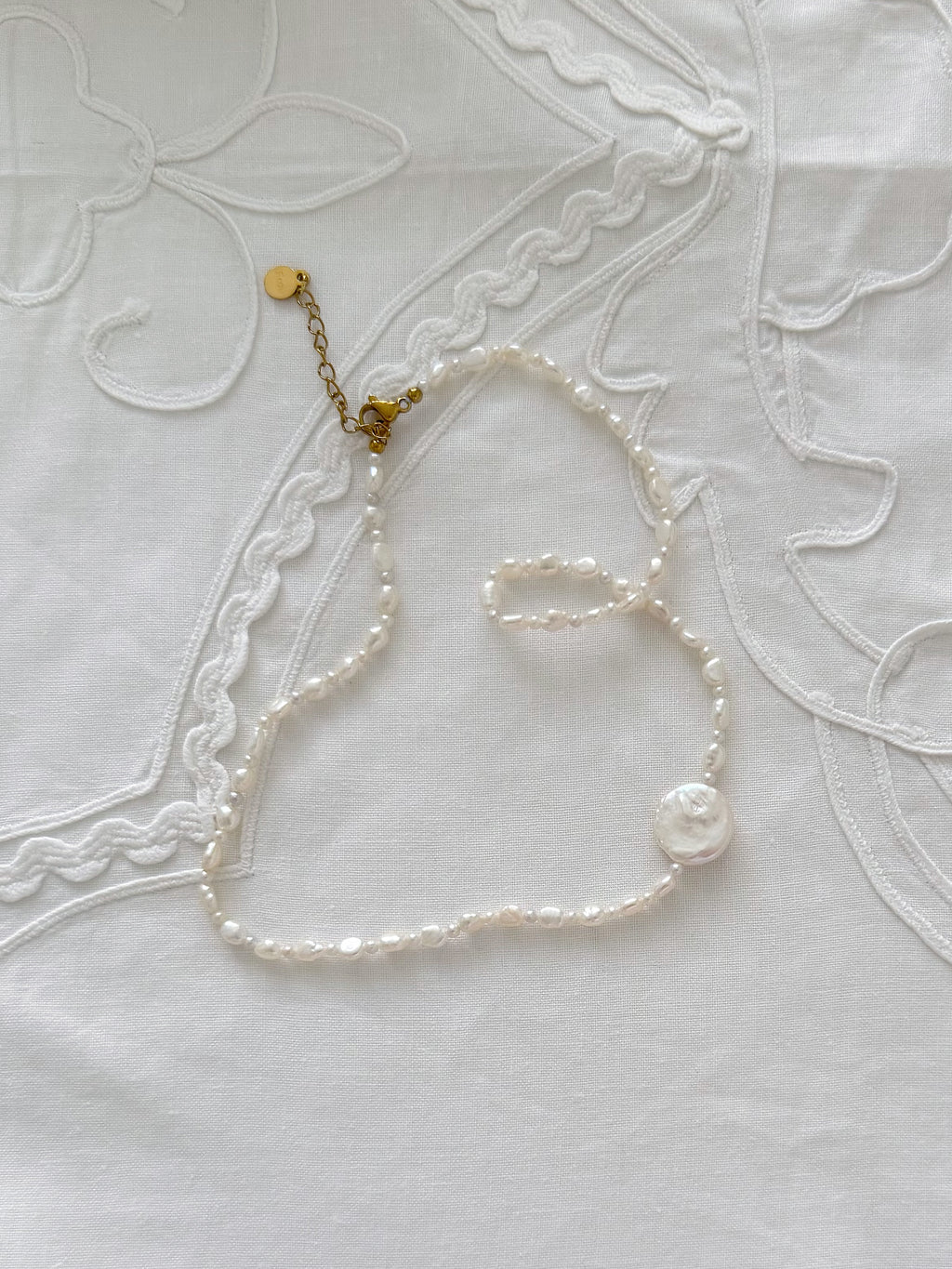 Freshwater pearl necklace detail with minimal styling and soft natural tones
