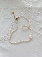 Freshwater pearl necklace detail with minimal styling and soft natural tones