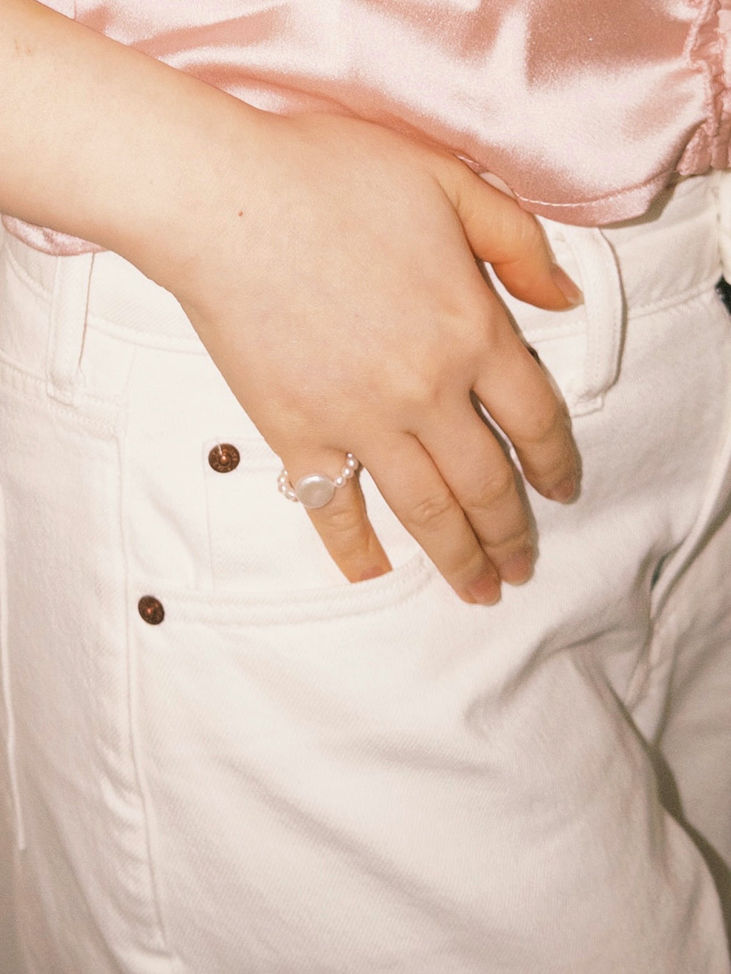 Pearl statement ring worn casually with soft neutral tones