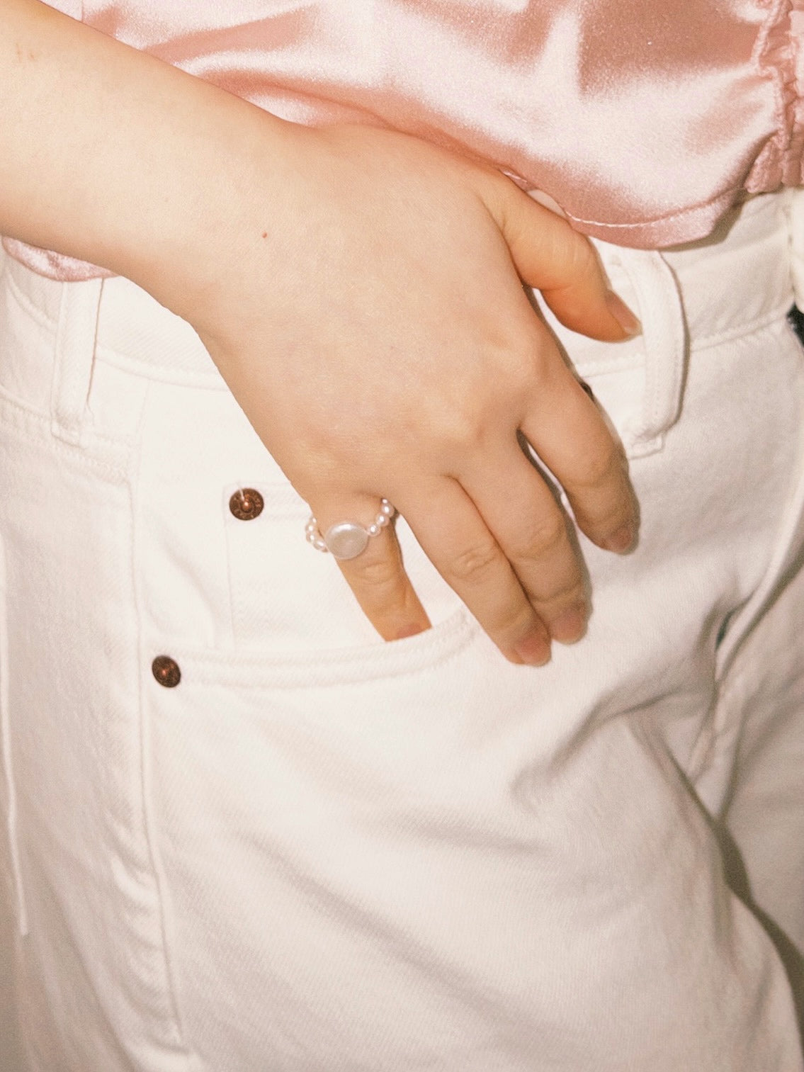 Pearl statement ring worn casually with soft neutral tones