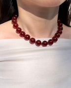 Red agate necklace worn on neck with bold everyday styling