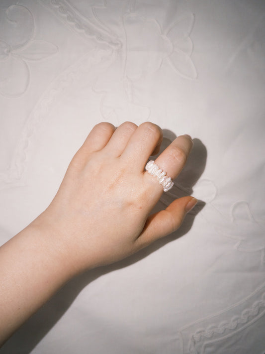 Pearl cross ring worn on hand with minimalist everyday styling