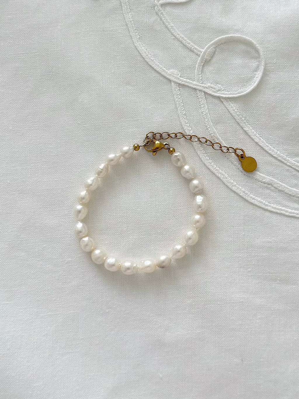 Freshwater pearl bracelet displayed on soft fabric with delicate minimal styling