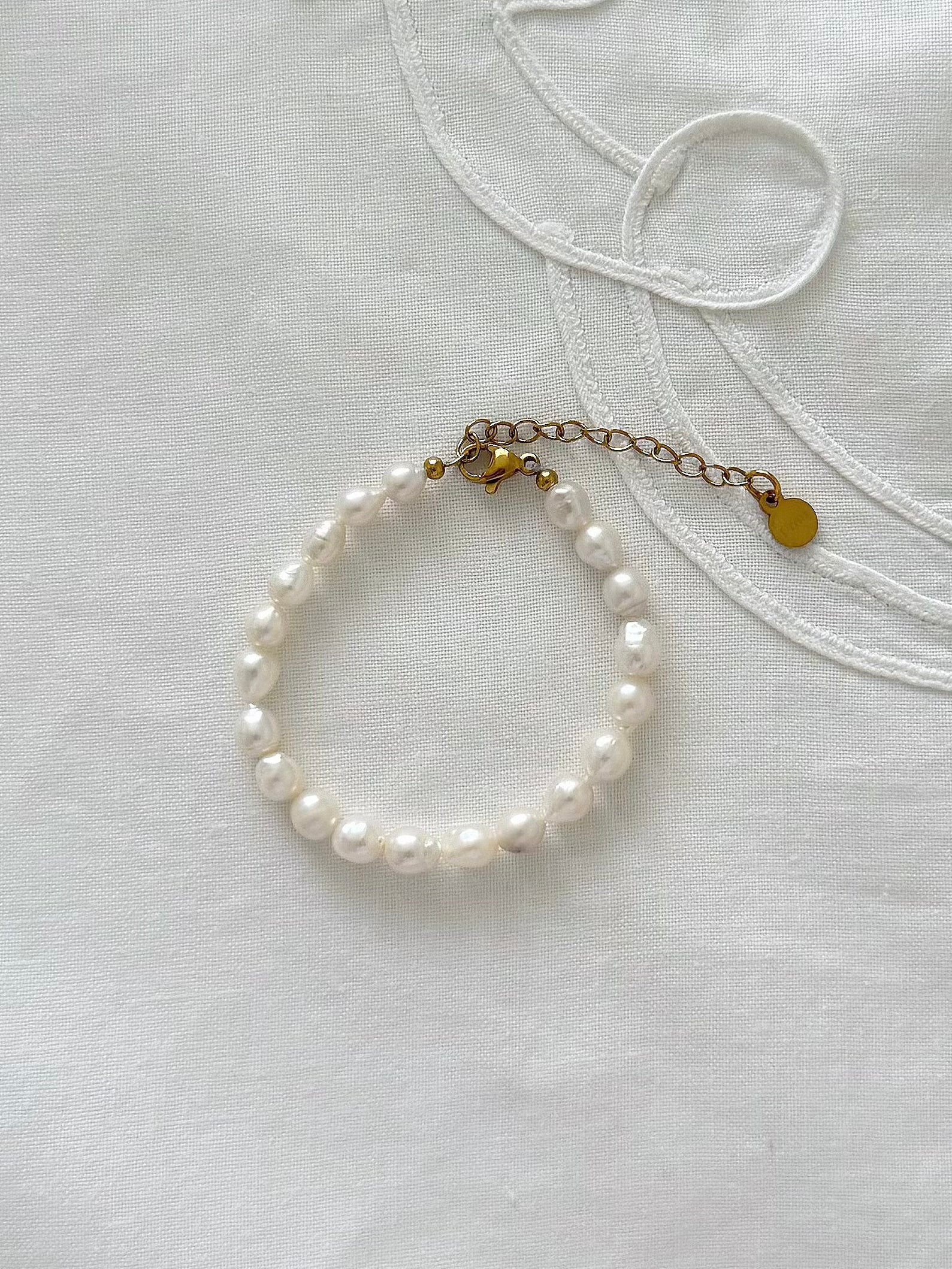 Freshwater pearl bracelet displayed on soft fabric with delicate minimal styling