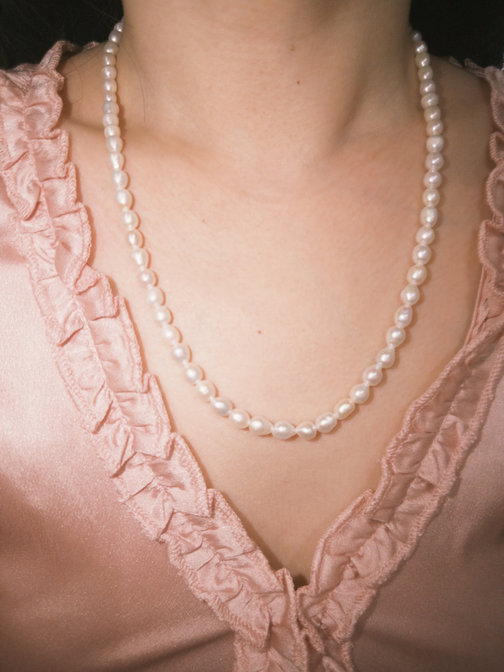 Minimal freshwater pearl necklace styled softly for everyday wear