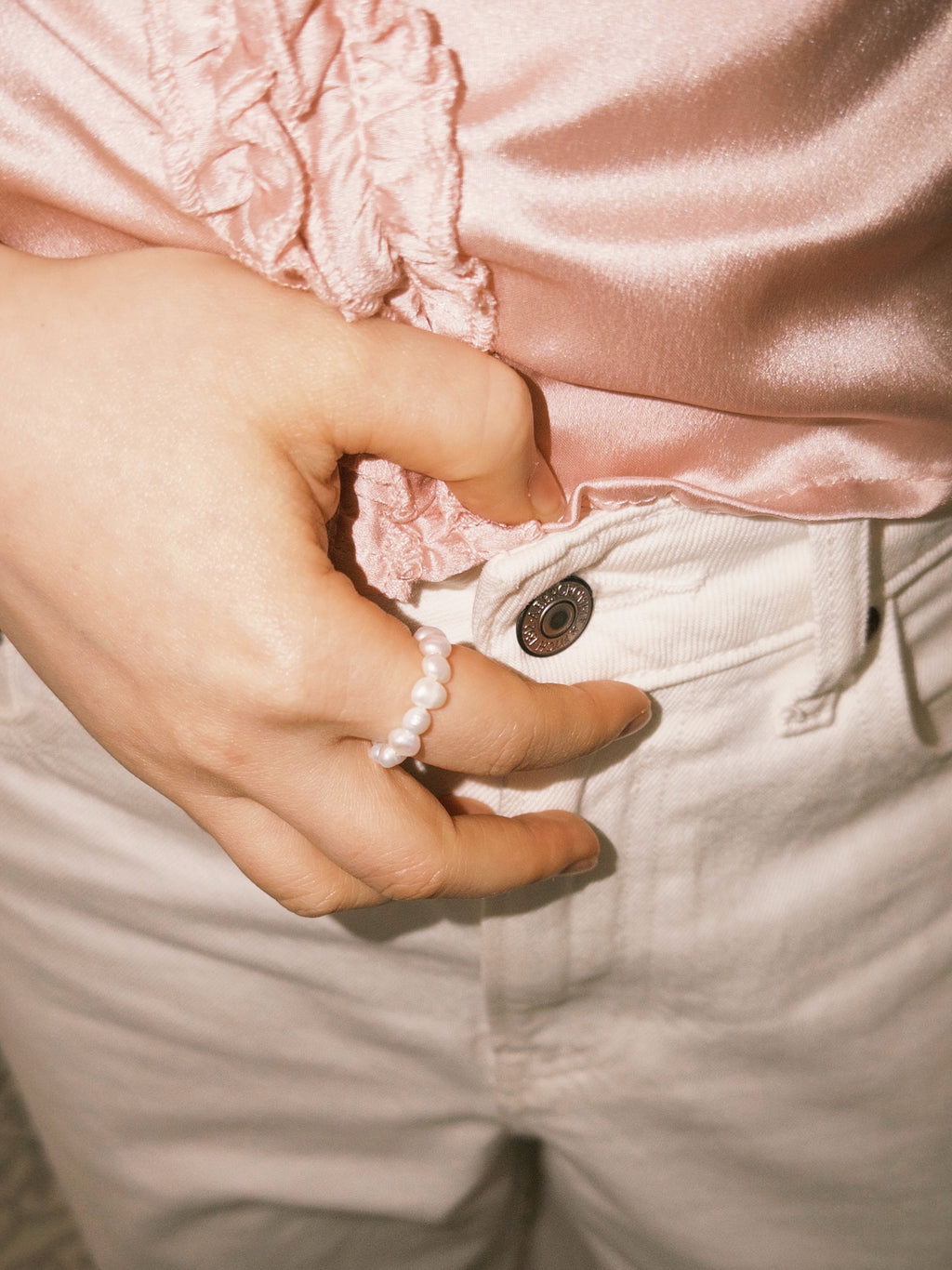 Pearl ring styled casually with soft neutral tones