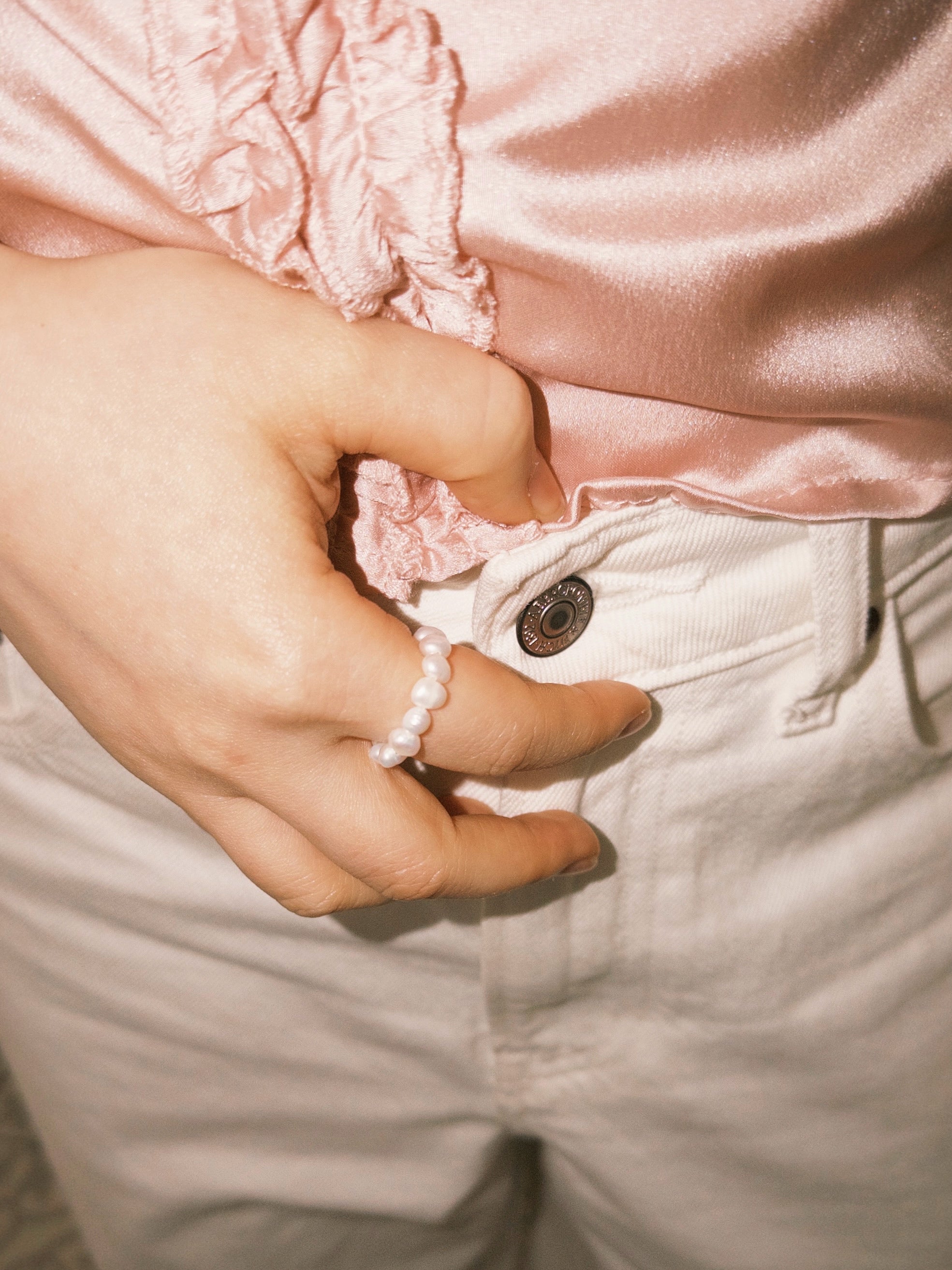 Pearl ring styled casually with soft neutral tones