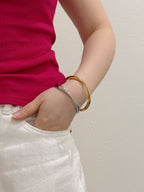 Minimal cuff bracelets styled with relaxed everyday outfit