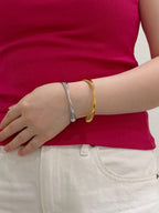 Gold and silver cuff bracelets styled together for everyday layering
